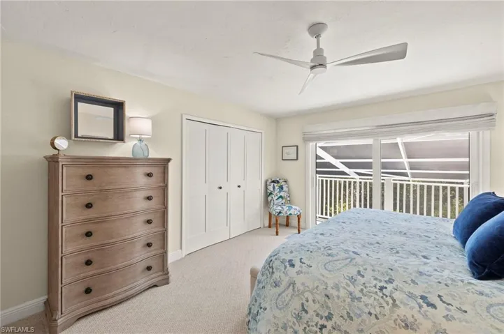 Bedroom with light carpet, access to outside, a closet, and ceiling fan