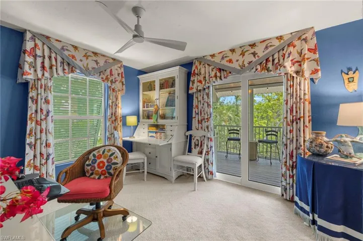 Living area with ceiling fan, plenty of natural light, and carpet flooring