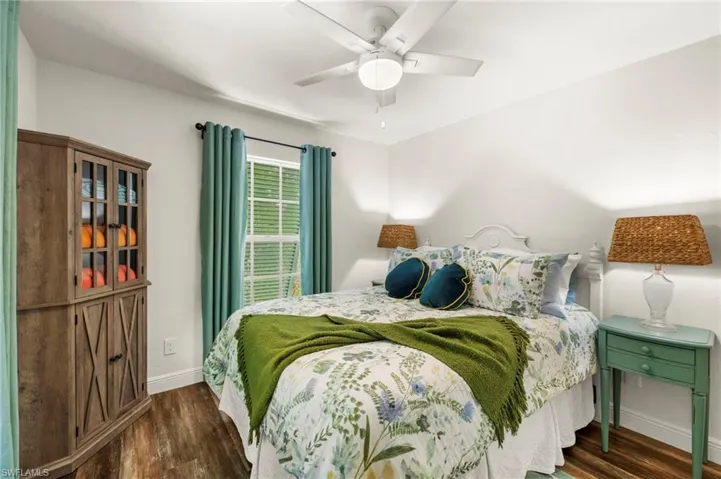 Bedroom with dark wood-style floors and ceiling fan