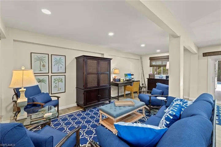 Living area featuring light wood-style floors, recessed lighting, and an office area