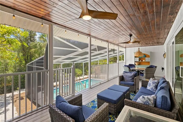Sunroom / solarium featuring an outdoor living space and a ceiling fan