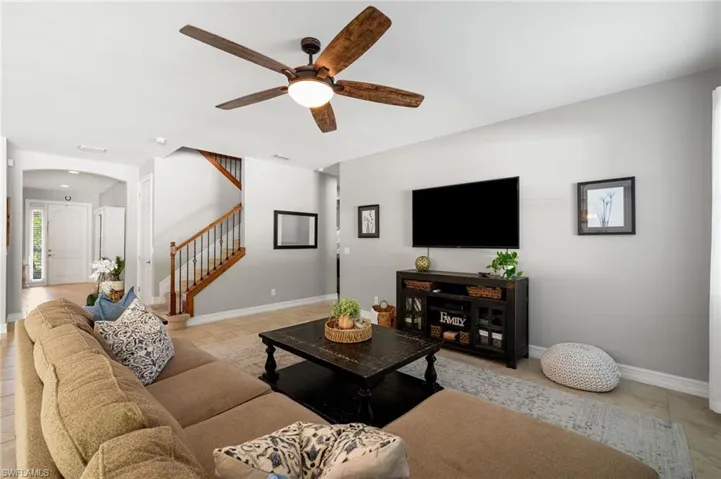 Tiled living room featuring ceiling fan