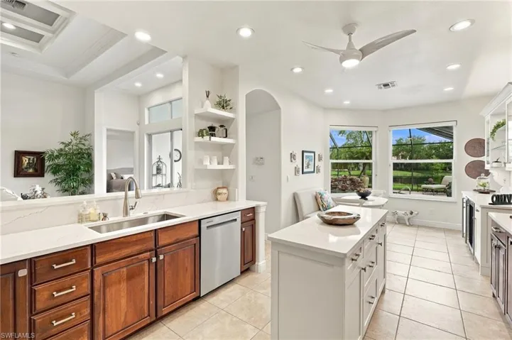 Kitchen featuring a central island, recessed lighting, and a tray ceiling