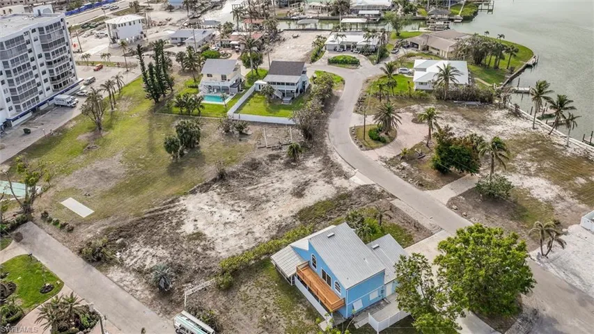 Birds eye view of property with a water view