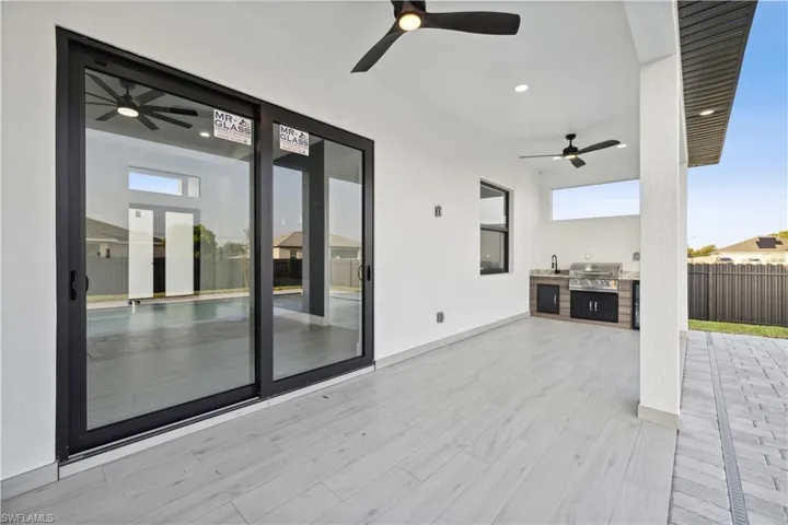 View of patio / terrace with area for grilling, exterior kitchen, and ceiling fan