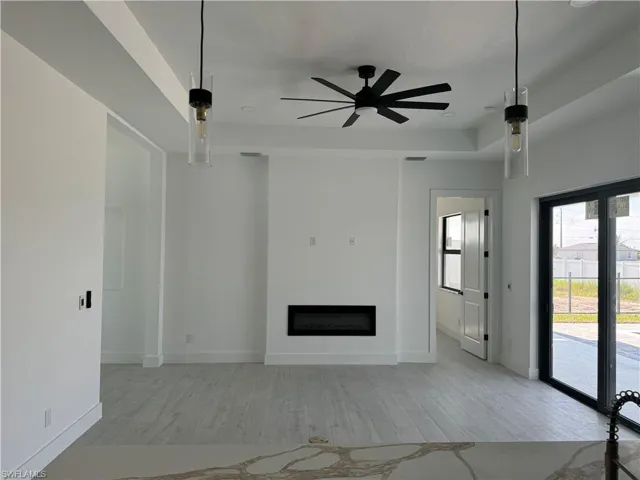Unfurnished living room featuring light hardwood / wood-style floors and ceiling fan