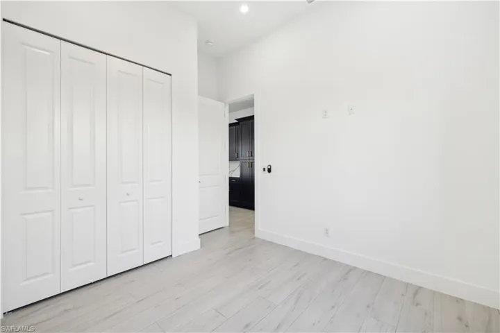 Unfurnished bedroom featuring light wood-type flooring and a closet