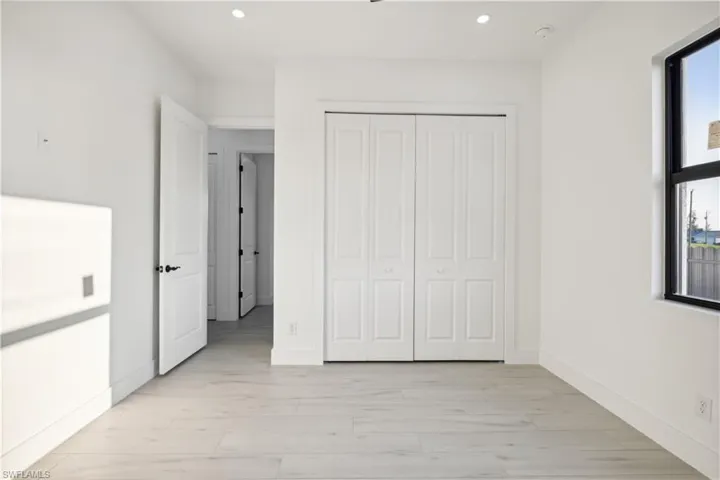 Unfurnished bedroom featuring a closet and light wood-type flooring