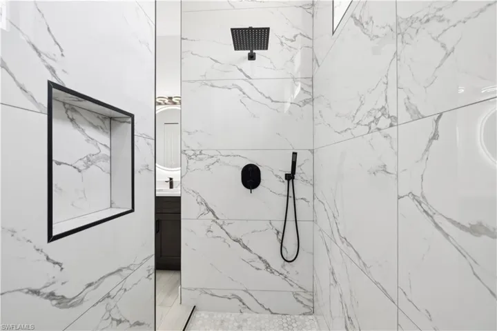 Bathroom with vanity and a tile shower