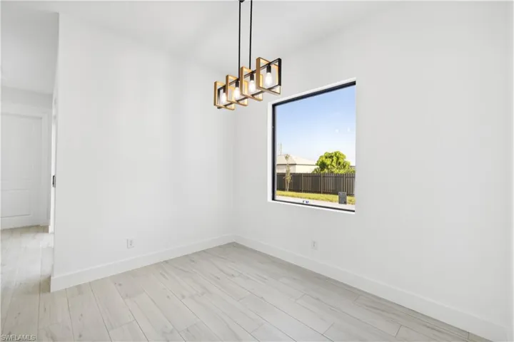 Unfurnished dining area featuring light hardwood / wood-style flooring and a notable chandelier