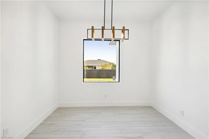 Unfurnished dining area featuring light hardwood / wood-style floors and an inviting chandelier