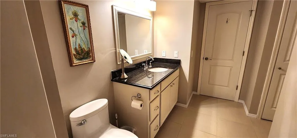 Bathroom featuring tile patterned floors, vanity, and toilet