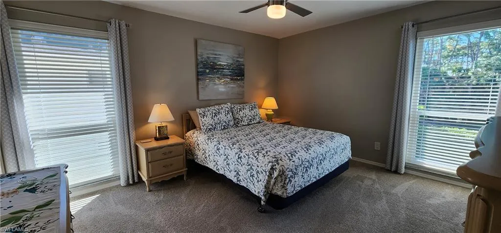 Carpeted bedroom with ceiling fan