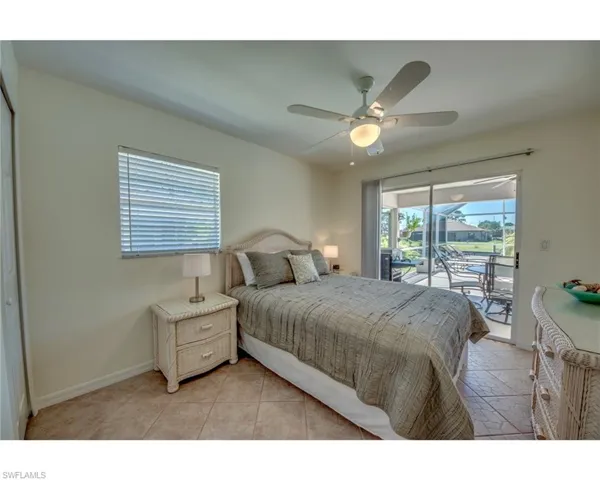 Bedroom with access to outside, ceiling fan, and light tile patterned floors