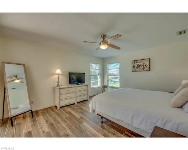 Bedroom featuring ceiling fan and light hardwood / wood-style flooring