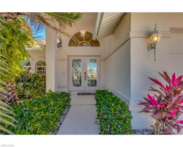 Property entrance featuring french doors