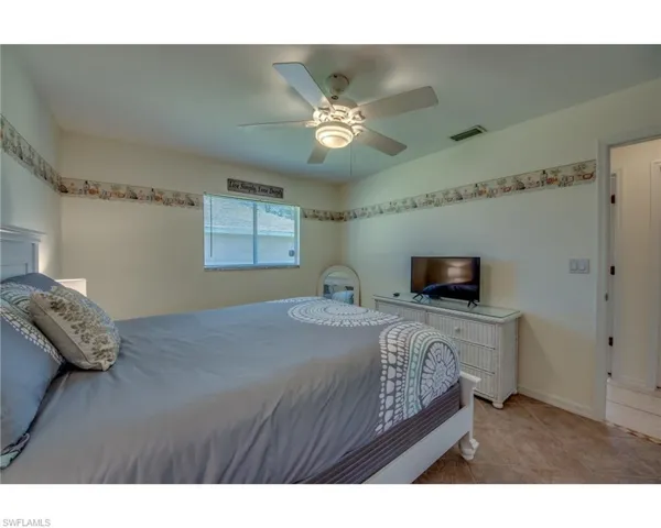 Tiled bedroom with ceiling fan