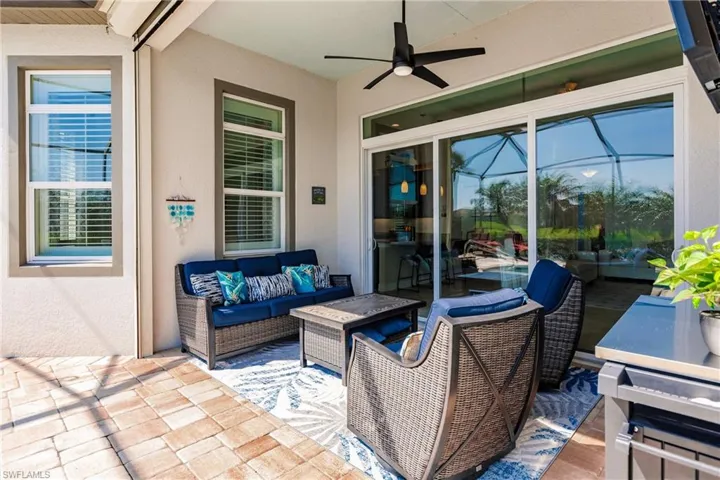 View of patio with outdoor lounge area and ceiling fan