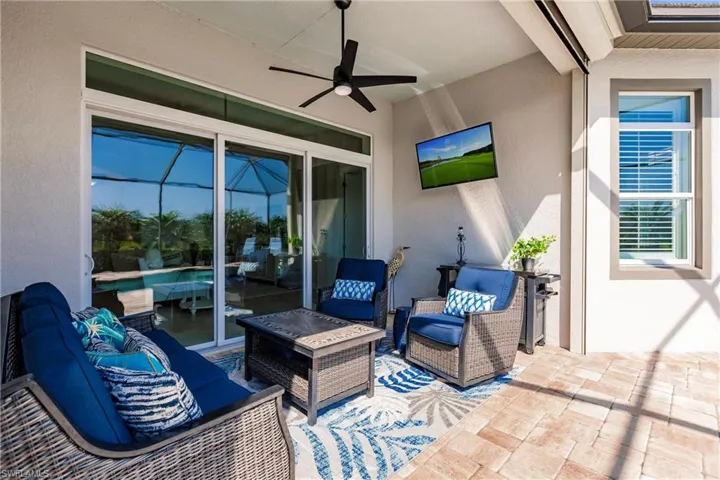 View of patio with an outdoor living space and ceiling fan