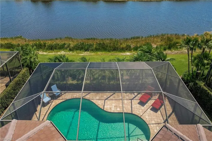View of pool with a lanai and a patio area