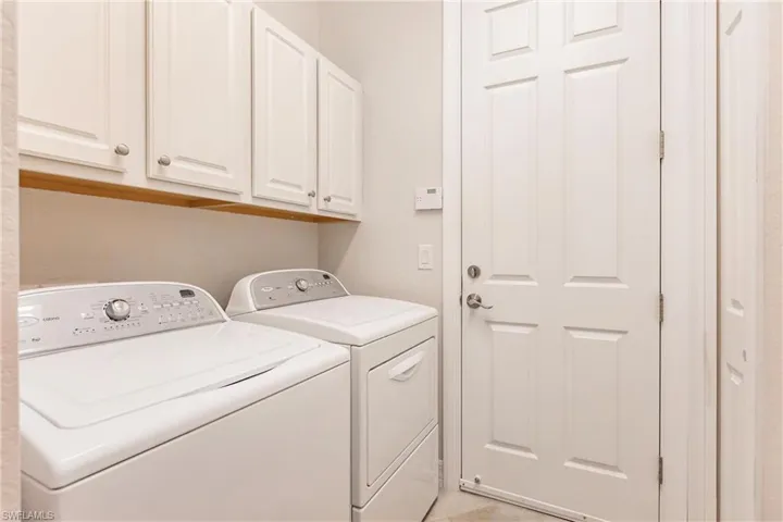Laundry area with cabinets and washer and clothes dryer