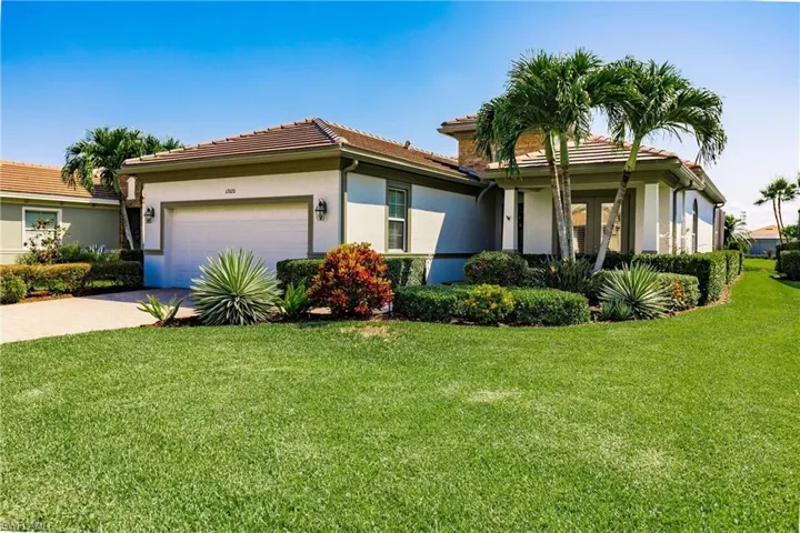 View of front of house featuring a garage and a front lawn