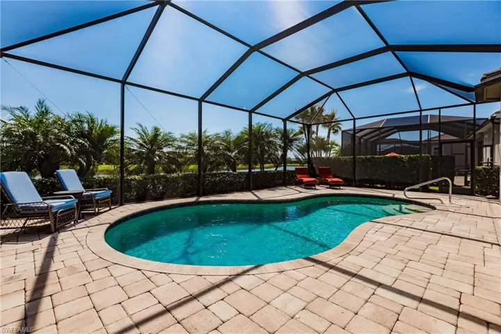 View of pool with a patio and a lanai