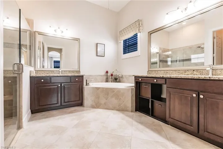 Bathroom featuring plus walk in shower, tile flooring, and vanity