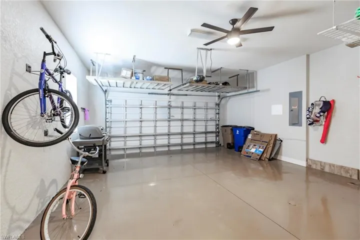 Garage featuring ceiling fan and a garage door opener