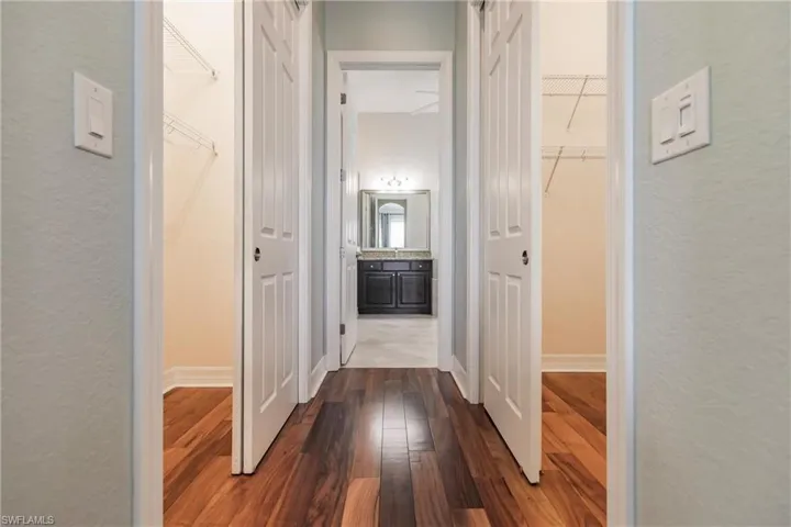 Hallway with dark wood-type flooring