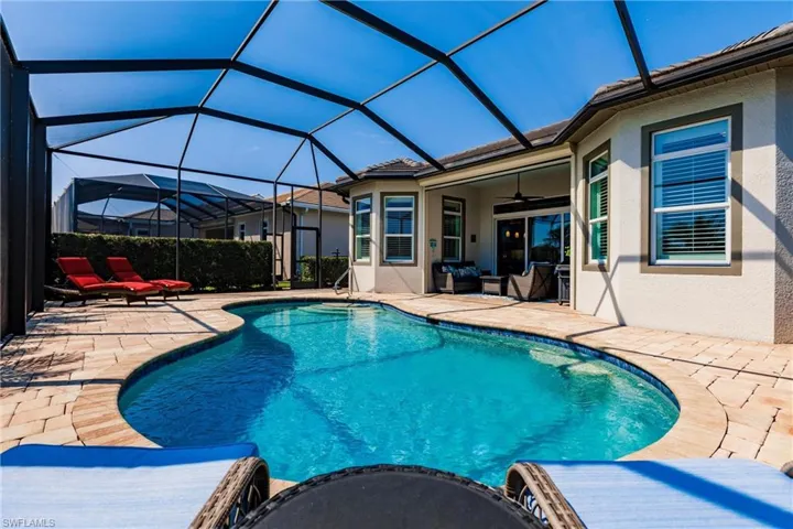 View of pool featuring a patio, a lanai, and ceiling fan