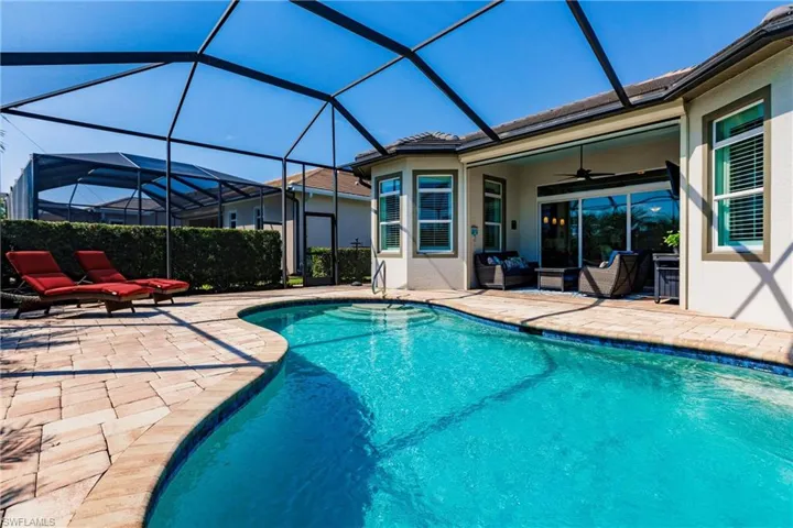 View of pool featuring outdoor lounge area, a lanai, a patio area, and ceiling fan