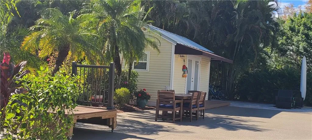 View of coach house with outdoor dining area