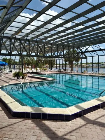 View of swimming pool with a lanai