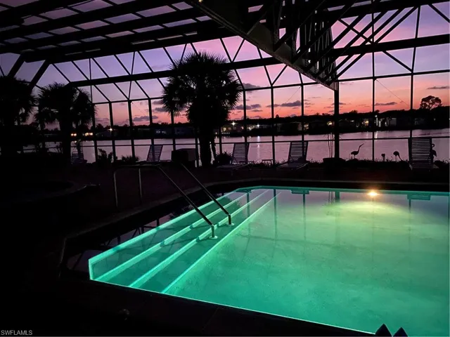 Pool at dusk with glass enclosure