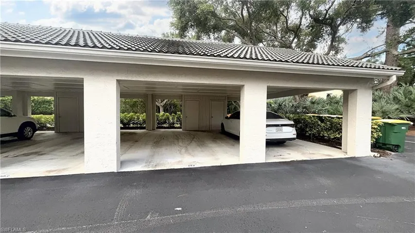 View of parking / parking lot with a carport