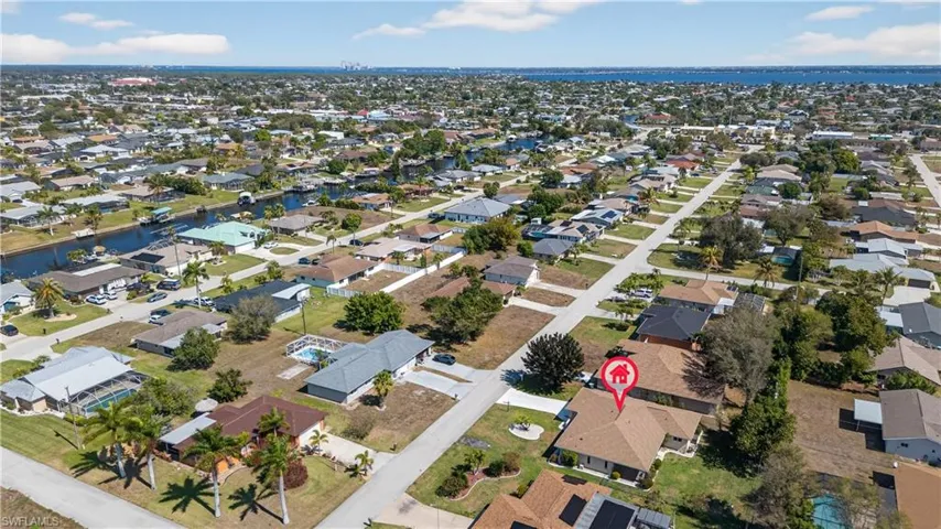 Aerial overview of property's location with nearby suburban area and a large body of water