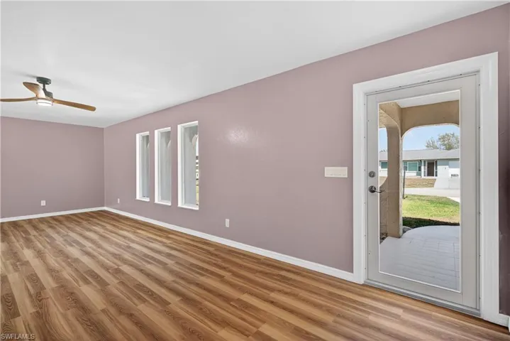 Front Living Room off entry featuring  ceiling fan, light wood finished floors, and plenty of natural light