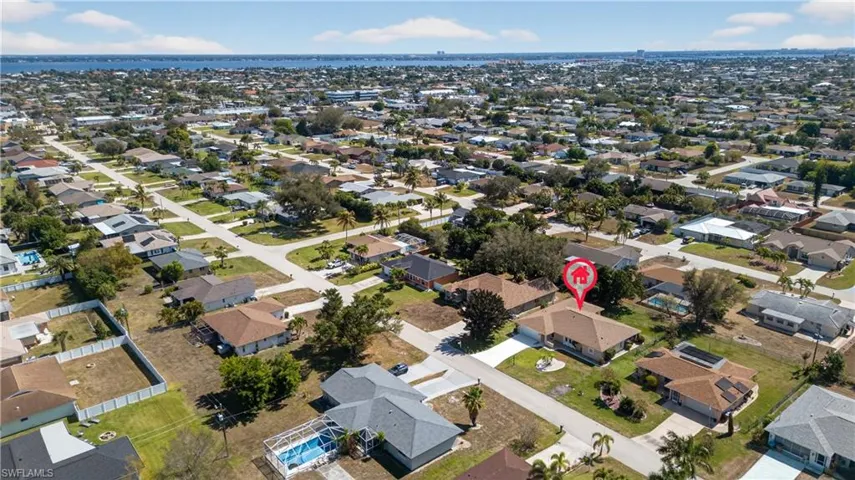 Aerial view of property's location featuring nearby suburban area