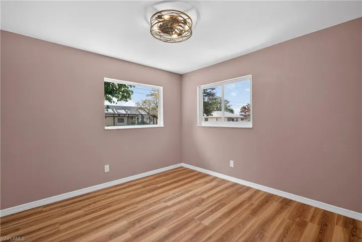 Bedroom 3 featuring natural light, walk in closet and upgraded new ceiling fan with lighs