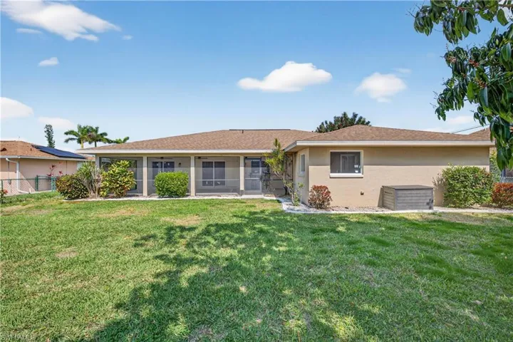 Fenced backyard with large mango tree and room for pool