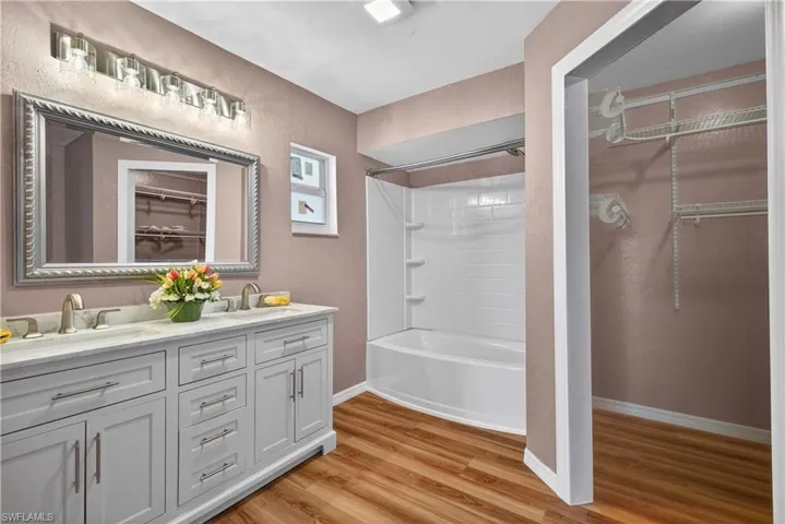 Primary Bathroom with new tub/shower & vanity and view of walk in closet