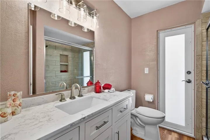 Guest bathroom with pool door to patio
