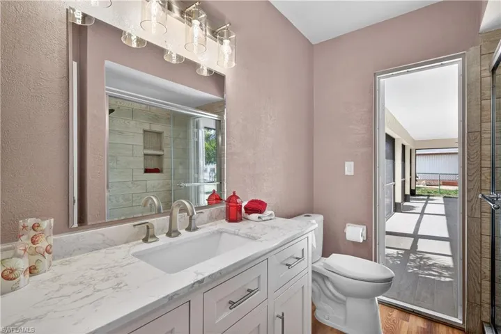 Guest bathroom with pool door to patio.  New shower, toilet and vanity