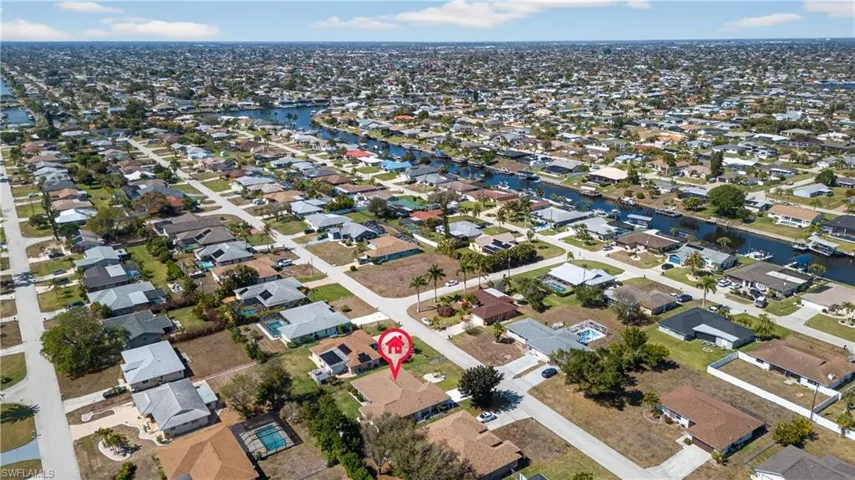 Aerial overview of property's location featuring nearby suburban area and a nearby body of water
