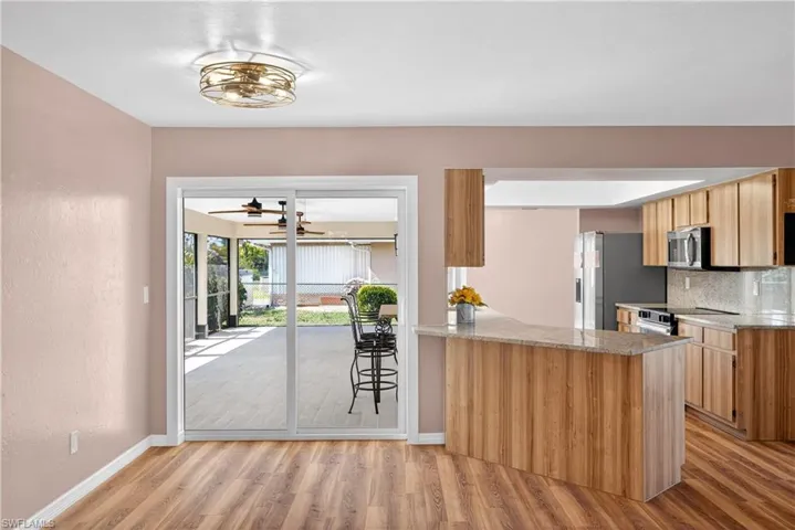 Sliding doors off Kitchen with room for a breakfast table and counter barstools