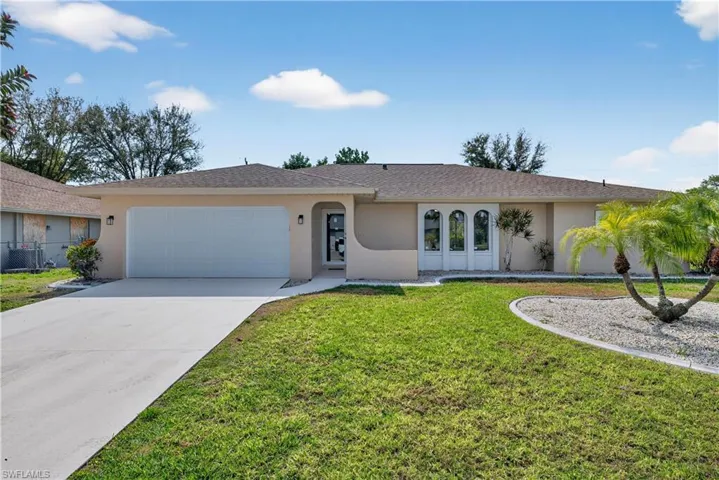 Ranch-style home featuring an attached garage, stucco siding, driveway, a front yard, and new roof with shingles
