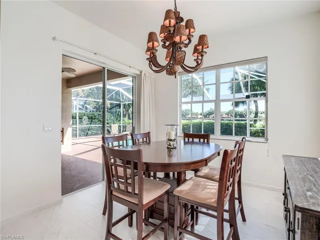 Tiled dining room with a notable chandelier