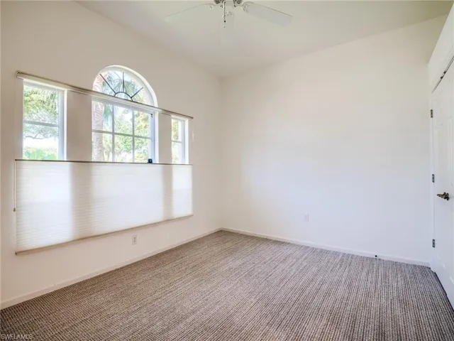 Carpeted #3 bedroom with ceiling fan