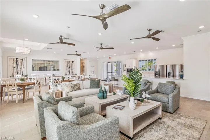 Living room with crown molding and light tile patterned floors